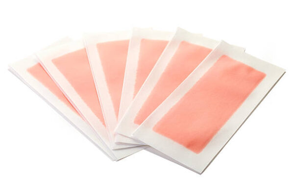 Pink waxing strips isolated on white background