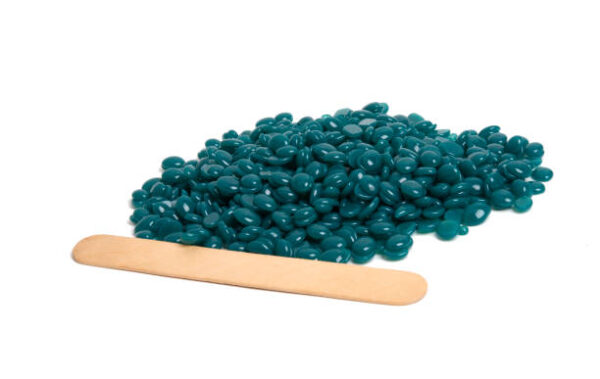 Spa wax for depilation in granular form on the white background